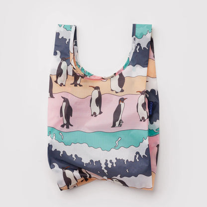 Reusable shopping bag with penguin design on a light gray background